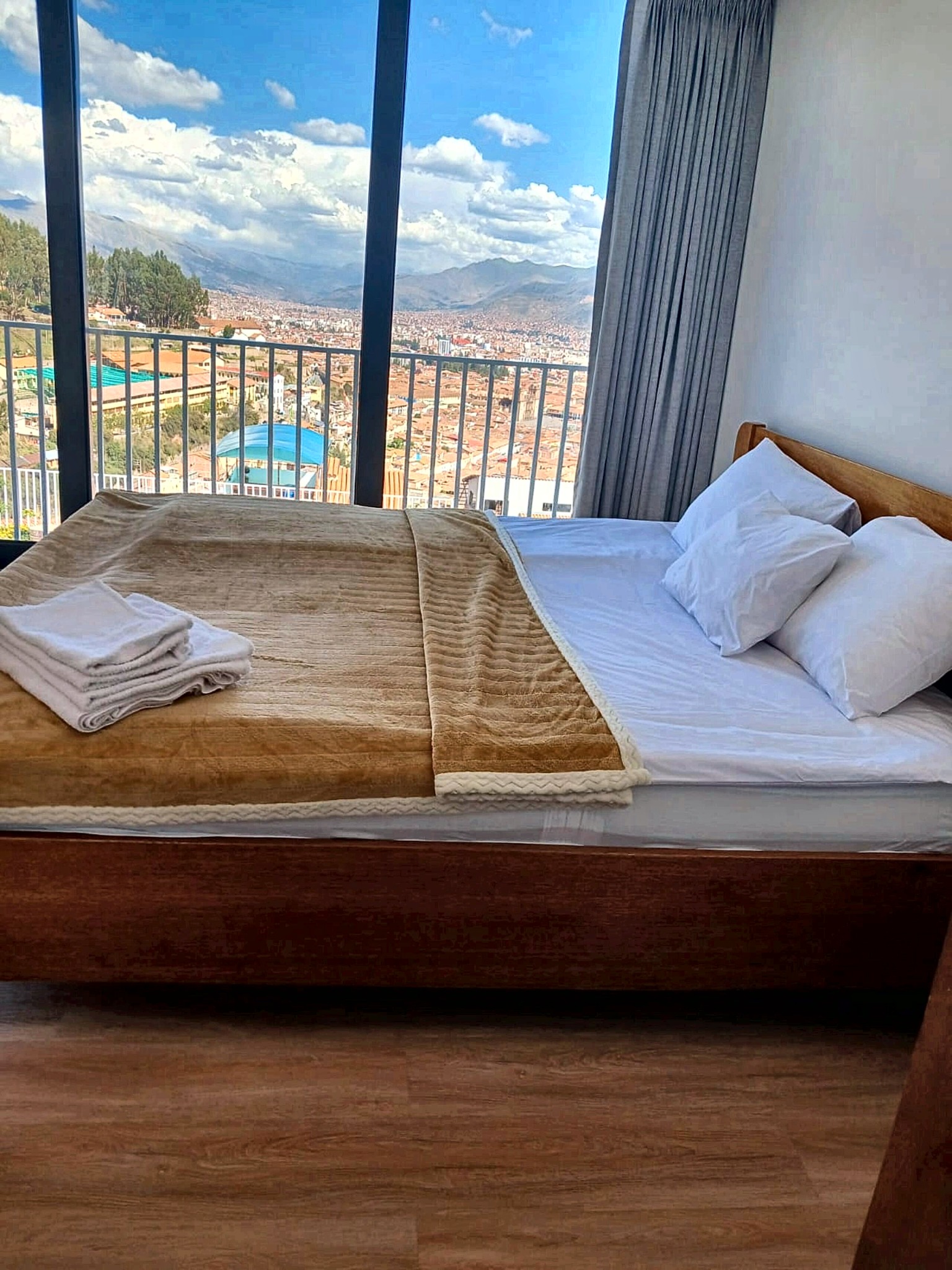 Bed in stone-bathed morning light with the view