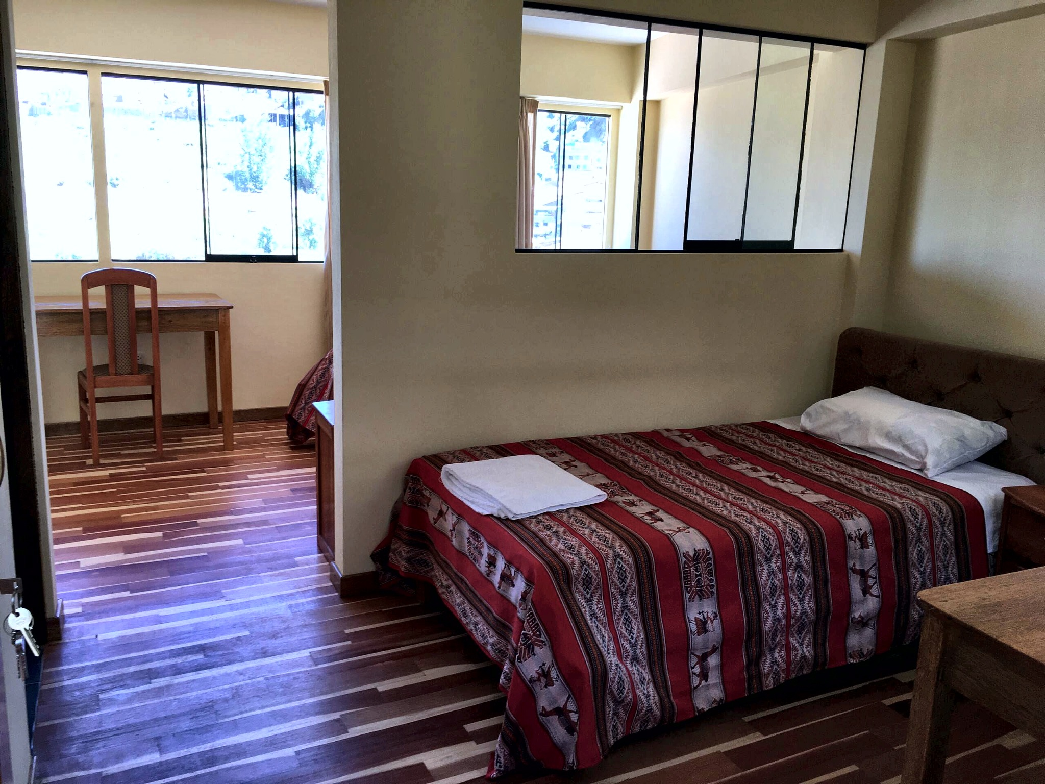 Bedroom with red Andean textiles