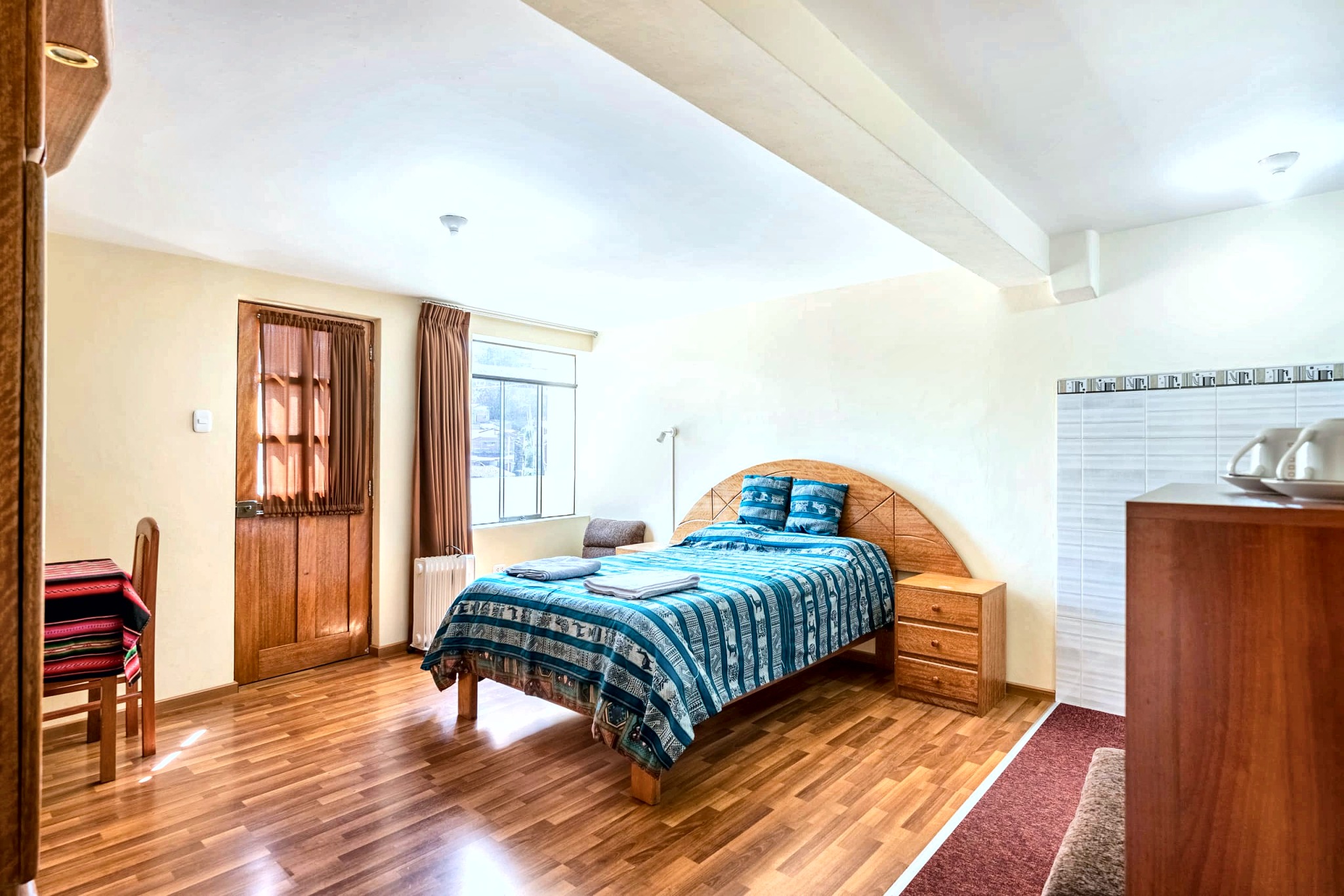 Bright bedroom with teal Andean textiles